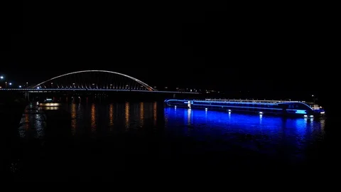 Ship crossing under bridge at night in european city. Stock Footage 120532126