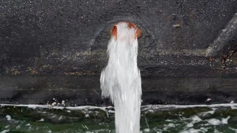 A ship docked at the pier pumping water into the sea. Stock Footage 251946299