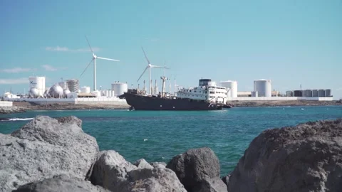 Ship docking at industrial harbor with wind turbines Stock Footage 293082320
