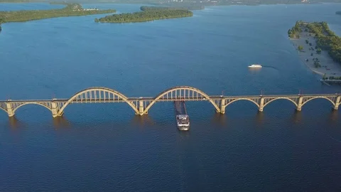 Ship floating on river under bridge Stock Footage 110736026