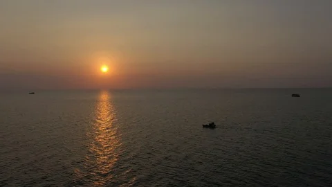 Ship floating on sea water in sunset red sun horizon line clear sky summer Stock Footage 124326053