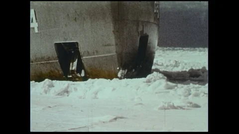 A ship forges through icy waters as a plane flies through cloudy conditions. Stock Footage