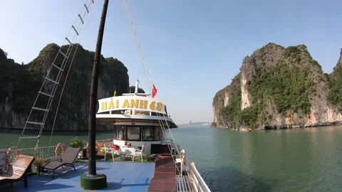 A ship goes between beautiful mountains, Halong Bay stunning landscape Stock Footage 166889927