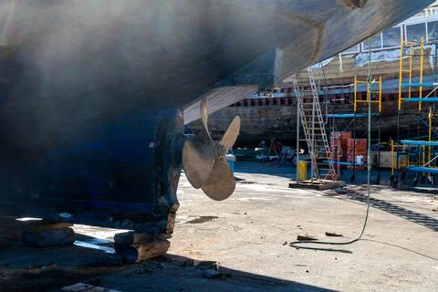 Ship hull and propeller on blocks in shipyard 写真素材