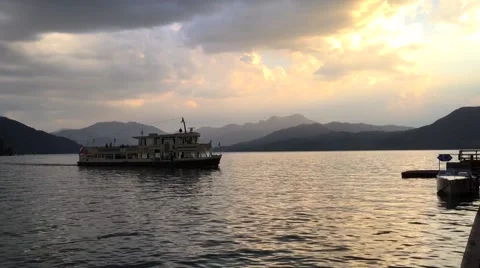 Ship on lake at sunset with cloudy sky Stock Footage 54220662