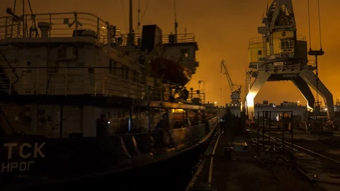 The ship leaves the shipyard dock at sunset. Stock Footage 86410939