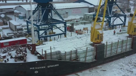 The ship is loaded in port in the winter by timber. Stock Footage 148762748