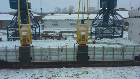 The ship is loaded in port in the winter by timber. Stock Footage 149083561