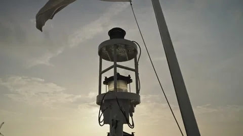 Ship mast navigation light and rigging against hazy sky at sunset Stock Footage 337913851