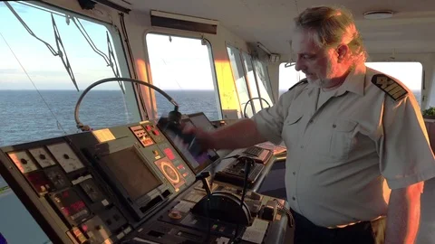Ship master talks on telephone and looks at blue endless sea Stock Footage 116608351