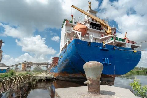 Ship moored at pier under loading. View from the aft stern prow. Stock Photos