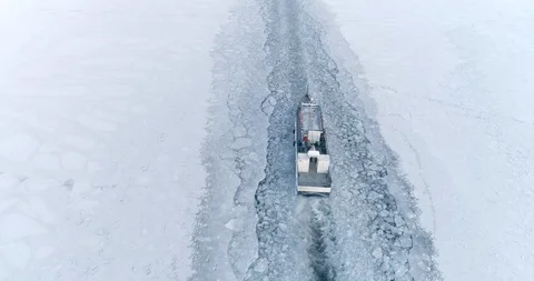 Ship Moving Along Empty Snow Covered Surface of Frozen Lake Baikal. Majestic Stock Footage 124245183