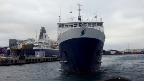 Ship moving close to camera in a port turning to dock Stock Footage 92638322
