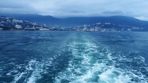 Ship is moving on the sea leaving behind a water trace Stock Footage 84744504