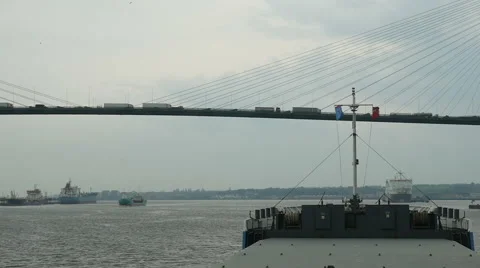 Ship navigating under the Dartford Crossing, while traffic passes overhead Stock Footage 64103904