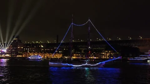 A Ship at night lit in colourful lights in Sydney Harbour 6K Stock Footage 330458211