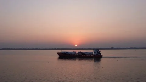 A ship or boat going through setting sun in Meghna River, aesthetic scene Stock Footage 301444336