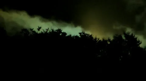 The ship from other planet flies behind a hill and shines bright lanterns Stock Footage 10683365