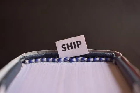 Ship Paper Tab Between Book Pages Symbolizing Ocean Journey, Navigation and.. Stock Photos