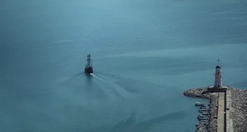The ship passes the lighthouse Stock Photos