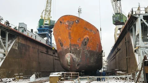 Ship in the process of repairing in dry dock at the shipyard. Video stock 86240093