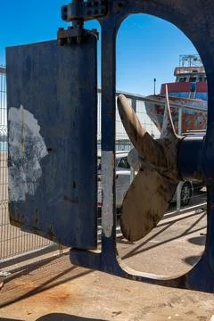 Ship propeller and rudder on dock during maintenance Stock Photos