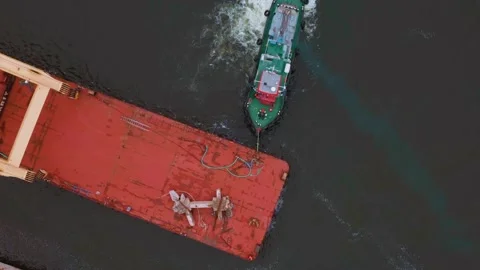 The ship is pulling the barge on the river Stock Footage 159493124