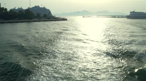 Ship put into harbor at sunset Stock Footage