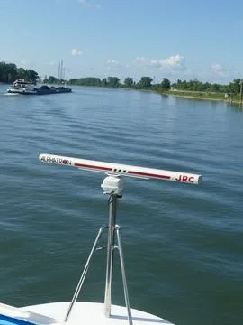 Ship radar antenna on deck overlooking a coal-loaded barge on the Rhine, il.. Stock Photos