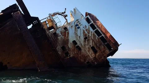 The ship ran aground. the cargo ship sank. storm and tsunami at sea. Stock Photos