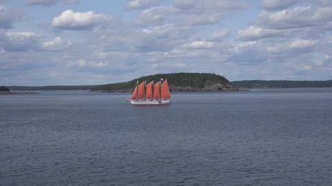 Ship with red sails sailing along Bar Harbor islands Stock Footage 113483907