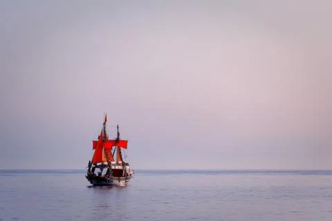 Ship with red sails in the sea Stock Photos
