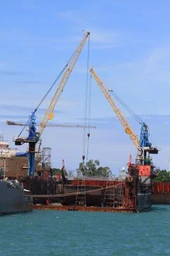 Ship for repairs in large floating dry dock Stock Photos