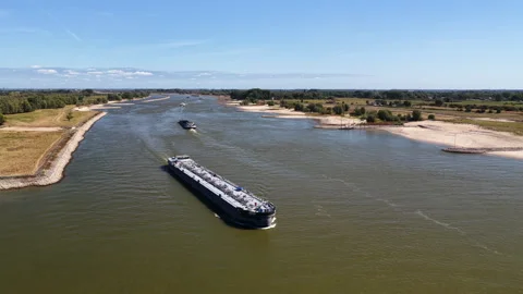 Ship on the river Waal during summer drought seen from above Stock Footage 342111182