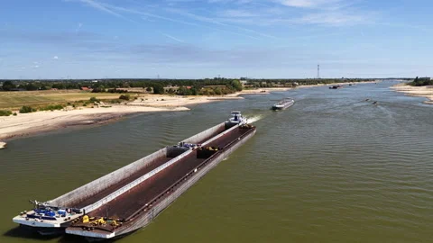Ship on the river Waal during summer drought seen from above Stock Footage 344394392