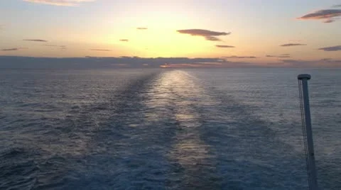 Ship Sailing Away from Sunset Video stock 10700830