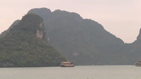 Ship sailing between mountain islands, Hạ Long Bay, North Vietnamm Stock Footage 53430618