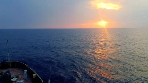 Ship sailing in blue sea during sunset or sunrise. Golden light of sun refl.. Stock-Footage 275567967