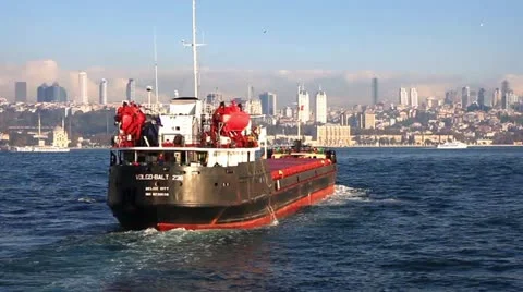 Ship sailing into city harbour Stock Footage