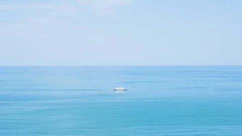 A ship sailing far in the turquoise sea. The view from the height. Stock Footage 114930833
