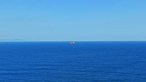Ship sailing on the open sea under a clear blue sky with calm waters in the Stock Footage 344810007