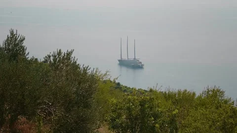 Ship sailing on open sea at windy day view from the coast to the sea. Stock Footage 296391869