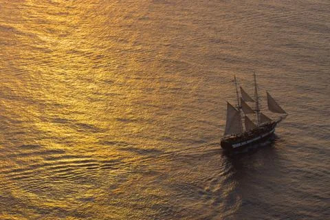 Ship sailing at sunset Stock Photos