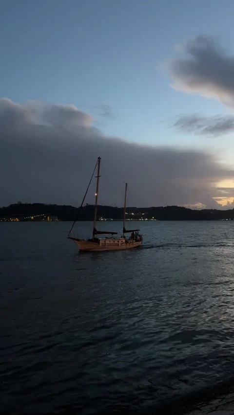 Ship sailing Tagus river in Lisbon in evening. Vertical video Stock Footage 241023705