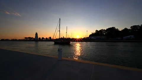 Ship sailing through dock during surise Stock Footage 202561950