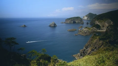 Ship Sailing through Ocean and Cliffs in Japan Stock Footage 98336033