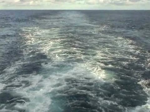Ship sailing through Pacific ocean in calm weather shot from aft Stock Footage 41194158