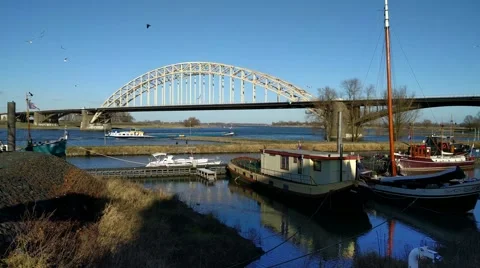 Ship sailing upstream under arch bridge, Waalbrug Nijmegen Stock-Footage 59861472