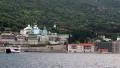 Ship sails along peninsula of Athos, autonomous monastic state in Greece HD Footage
