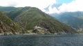 Ship sails along peninsula of Athos, autonomous monastic state in Greece HD Footage